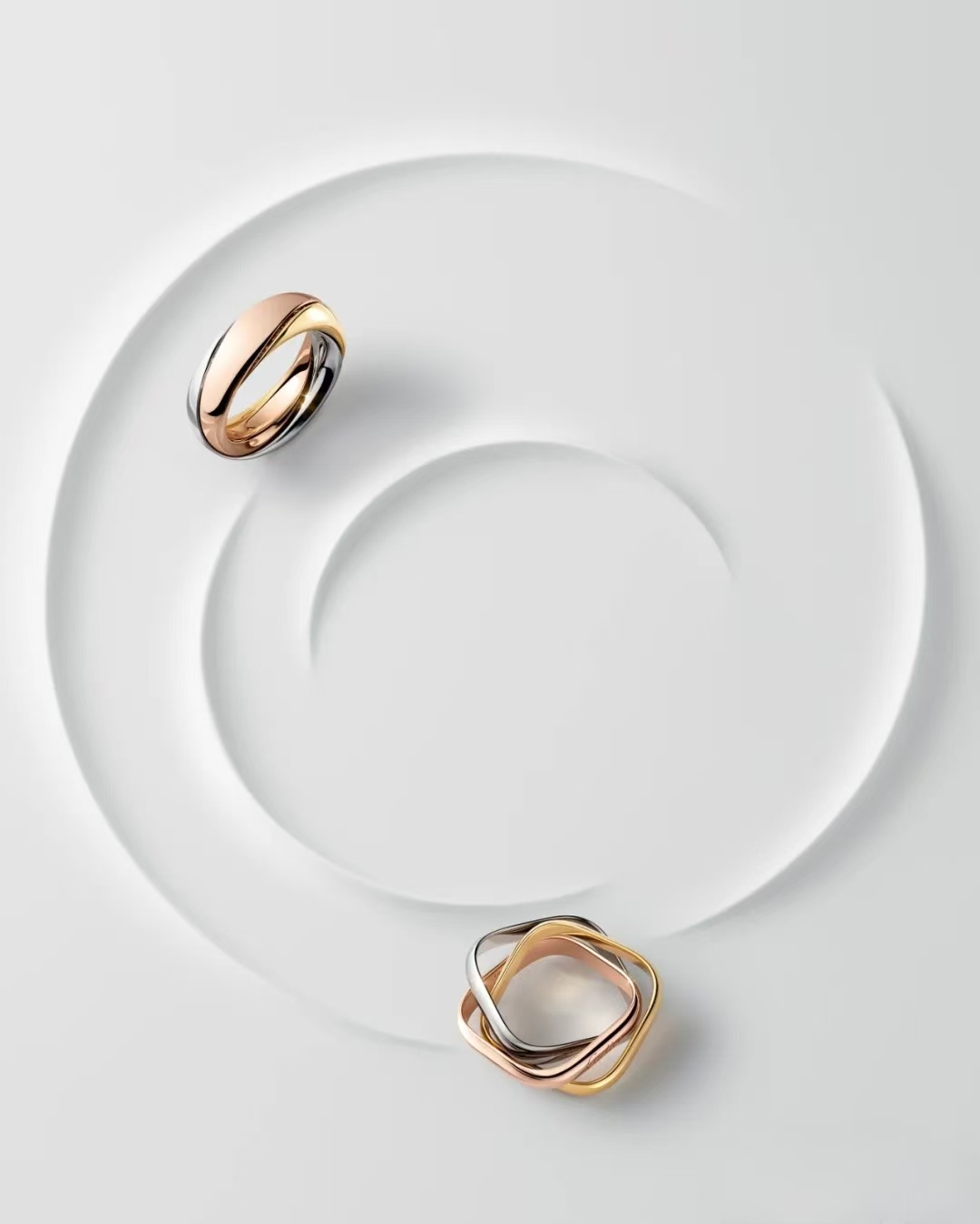 Cartier Trinity collection, featuring three intertwined rings of rose gold, white gold, and yellow gold, symbolizing friendship, loyalty, and love.